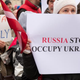Protesters hold up placards during a demonstration against Russia’s aggression in Ukraine at the Russian Embassy in Riga, Latvia, March 2, 2014.
ILMARS ZNOTINS/AFP/Getty Images